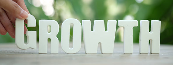 Hand arrange white letters as GROWTH